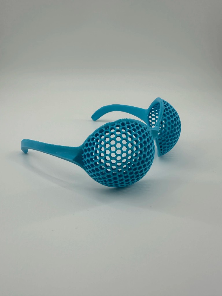 Cyan eyewear with spherical honeycomb lattice lenses