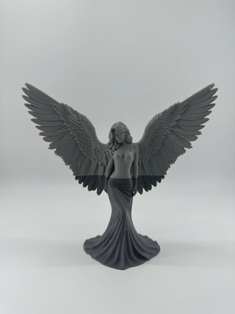 Grey winged angel figurine with flowing gown