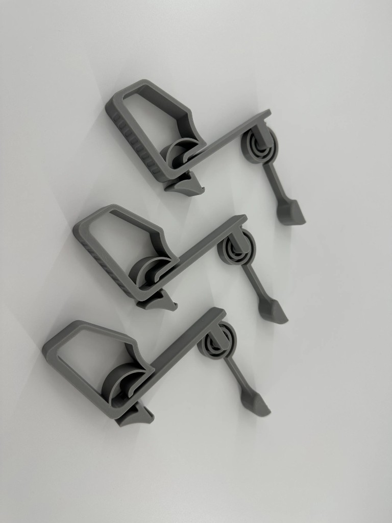 Set of three grey hinged mechanical clips