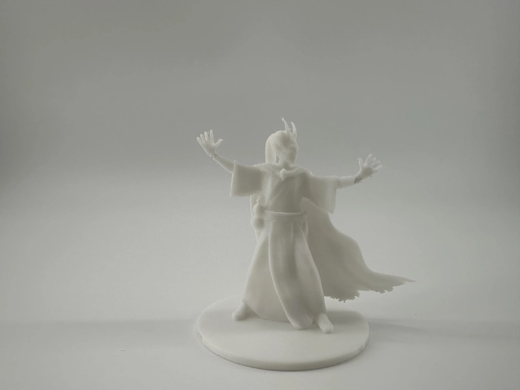 White mage figurine in casting pose with cape